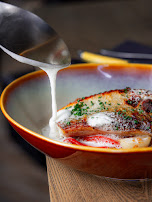 Sauce being poured over a restaurant dish