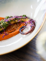 A plated seafood dish with herbs